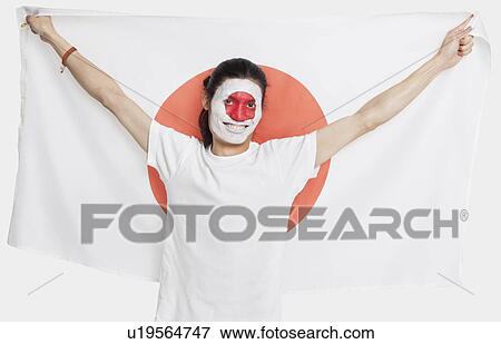 Portrait of young Asian man with Japanese flag smiling against white background View Large Photo Image Stock Photo - Portrait of young Asian man with Japanese flag smiling against white background. Fotosearch
