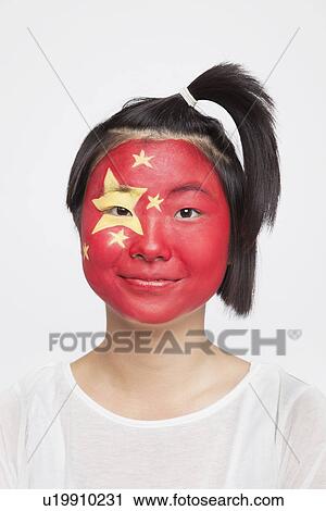 Portrait of young Asian woman with Chinese flag painted on face against white background View Large Photo Image Stock Image - Portrait of young Asian woman with Chinese flag painted on face against white background. Fotosearch
