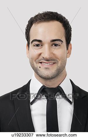 Portrait of young Caucasian businessman smiling against white background View Large Photo Image Stock Photo - Portrait of young Caucasian businessman smiling against white background. Fotosearch