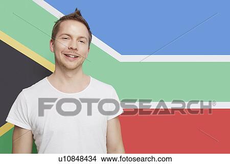Portrait of young Caucasian man smiling against South African flag View Large Photo Image Picture - Portrait of young Caucasian man smiling against South African flag. Fotosearch
