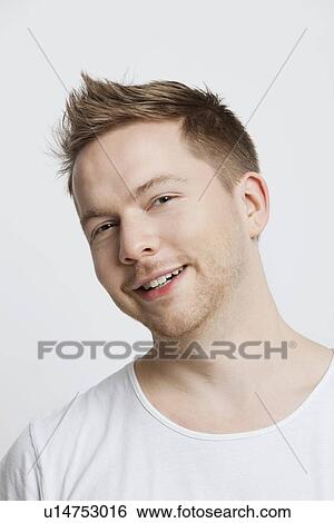 Portrait of young Caucasian man with spiked hair smiling against white background View Large Photo Image Stock Photograph - Portrait of young Caucasian man with spiked hair smiling against white background. Fotosearch