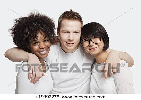 Portrait of young Caucasian man with his arms around two female friends over white background View Large Photo Image Stock Photography - Portrait of young Caucasian man with his arms around two female friends over white background. Fotosearch