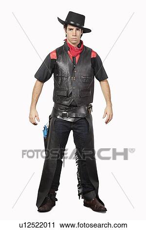 Portrait of young cowboy in black leather vest standing against gray background View Large Photo Image Stock Image - Portrait of young cowboy in black leather vest standing against gray background. Fotosearch