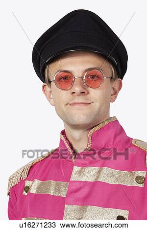 Portrait of young male marching band member in pink colored costume against gray background View Large Photo Image Stock Image - Portrait of young male marching band member in pink colored costume against gray background. Fotosearch