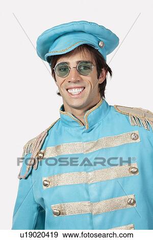 Portrait of young male marching band member in blue costume smiling against gray background View Large Photo Image Stock Photo - Portrait of young male marching band member in blue costume smiling against gray background. Fotosearch