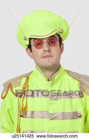 Portrait of young male marching band member in green colored costume against gray background View Large Photo Image Stock Photography - Portrait of young male marching band member in green colored costume against gray background. Fotosearch