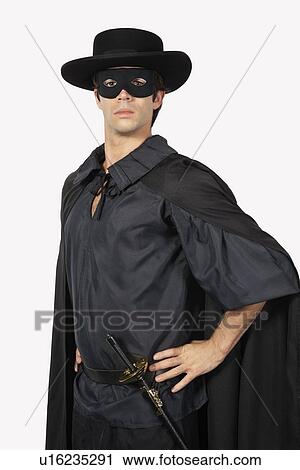 Portrait of young man dressed as Zorro against gray background View Large Photo Image Stock Image - Portrait of young man dressed as Zorro against gray background. Fotosearch