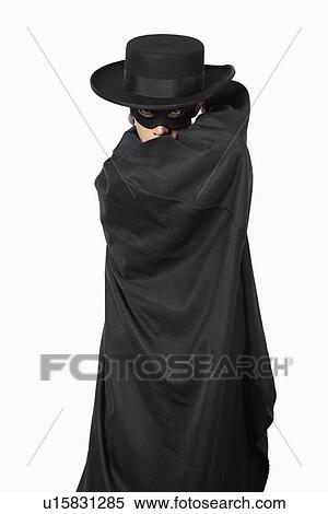 Portrait of young man dressed as Zorro over gray background View Large Photo Image Stock Photography - Portrait of young man dressed as Zorro over gray background. Fotosearch