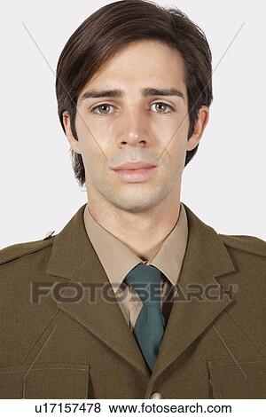 Portrait of young man in military uniform against gray background View Large Photo Image Stock Photo - Portrait of young man in military uniform against gray background. Fotosearch