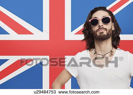 Portrait of young man in white t-shirt wearing sunglasses against British flag View Large Photo Image Stock Image - Portrait of young man in white t-shirt wearing sunglasses against British flag. Fotosearch