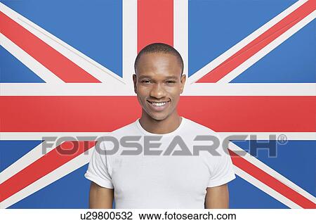 Portrait of young man in white t-shirt smiling against British flag View Large Photo Image Stock Image - Portrait of young man in white t-shirt smiling against British flag. Fotosearch