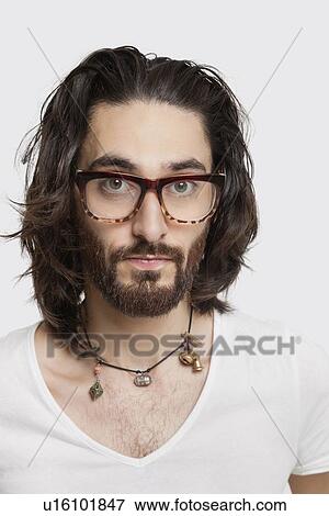 Portrait of young man in white t-shirt wearing eyeglasses against white background View Large Photo Image Stock Photo - Portrait of young man in white t-shirt wearing eyeglasses against white background. Fotosearch