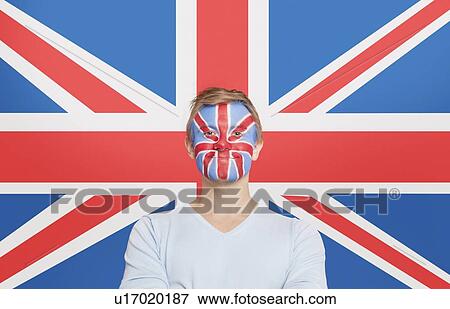 Portrait of young man in white t-shirt with face painting against British flag View Large Photo Image Stock Photo - Portrait of young man in white t-shirt with face painting against British flag. Fotosearch