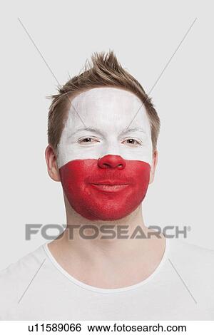 Portrait of young man with Polish flag painted on face smiling against white background View Large Photo Image Stock Photograph - Portrait of young man with Polish flag painted on face smiling against white background. Fotosearch