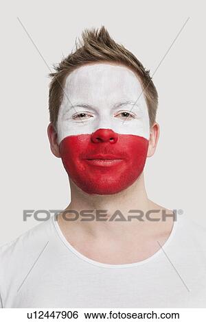 Portrait of young man with Polish flag painted on face smiling against white background View Large Photo Image Stock Photograph - Portrait of young man with Polish flag painted on face smiling against white background. Fotosearch