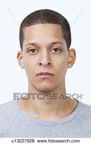Portrait of young mixed race man against white background View Large Photo Image Stock Photo - Portrait of young mixed race man against white background. Fotosearch