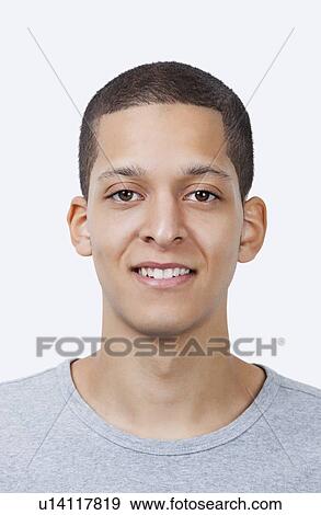 Portrait of young mixed race man smiling against white background View Large Photo Image Stock Photo - Portrait of young mixed race man smiling against white background. Fotosearch