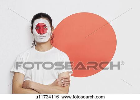 Portrait of young mixed race person with painted face and arms crossed against Japanese flag View Large Photo Image Stock Photograph - Portrait of young mixed race person with painted face and arms crossed against Japanese flag. Fotosearch