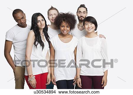 Portrait of young multi-ethnic friends in casuals smiling together over white background View Large Photo Image Picture - Portrait of young multi-ethnic friends in casuals smiling together over white background. Fotosearch