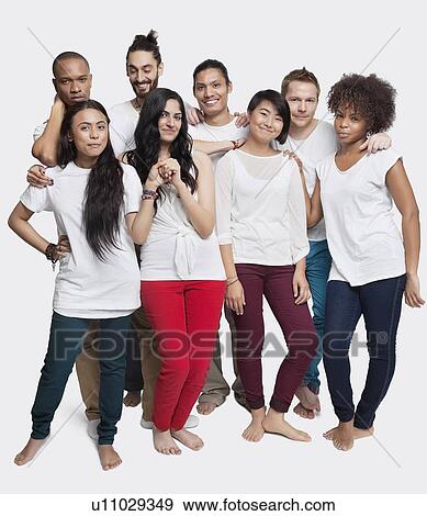 Portrait of young multi-ethnic friends posing together against white background View Large Photo Image Stock Photo - Portrait of young multi-ethnic friends posing together against white background. Fotosearch
