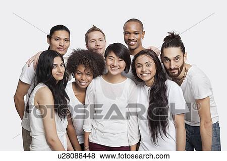 Stock Photo - Portrait of young multi-ethnic friends smiling together against white background. Fotosearch