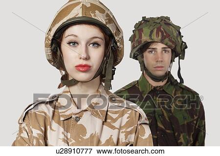 Portrait of young woman and man in military clothes against gray background View Large Photo Image Stock Photo - Portrait of young woman and man in military clothes against gray background. Fotosearch