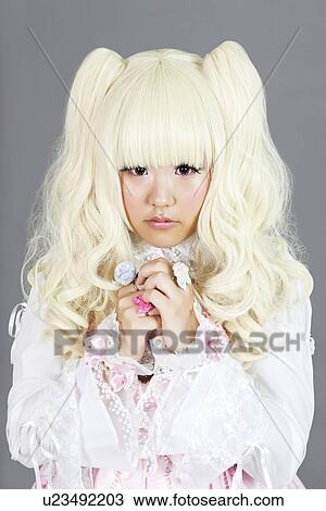 Portrait of young woman dressed as a doll over gray background View Large Photo Image Stock Image - Portrait of young woman dressed as a doll over gray background. Fotosearch