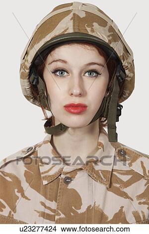 Portrait of young woman in military uniform against gray background View Large Photo Image Picture - Portrait of young woman in military uniform against gray background. Fotosearch