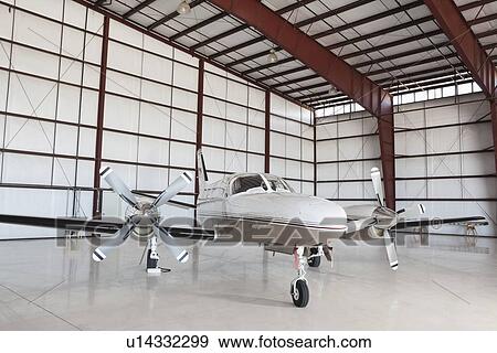 Private airplane parked in hangar View Large Photo Image Stock Photo - Private airplane parked in hangar. Fotosearch