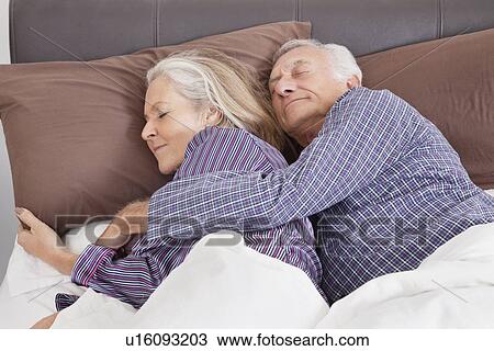 Romantic senior couple sleeping on bed at home View Large Photo Image Stock Image - Romantic senior couple sleeping on bed at home. Fotosearch