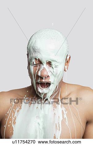 Shirtless young man covered in paint with mouth open against gray background View Large Photo Image Stock Image - Shirtless young man covered in paint with mouth open against gray background. Fotosearch