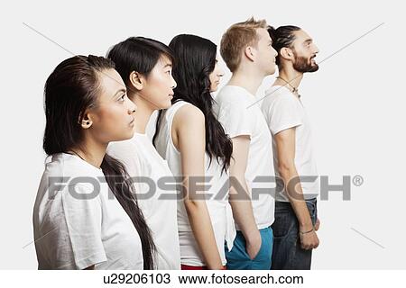 Side view of young multi-ethnic friends in casuals over white background View Large Photo Image Stock Image - Side view of young multi-ethnic friends in casuals over white background. Fotosearch