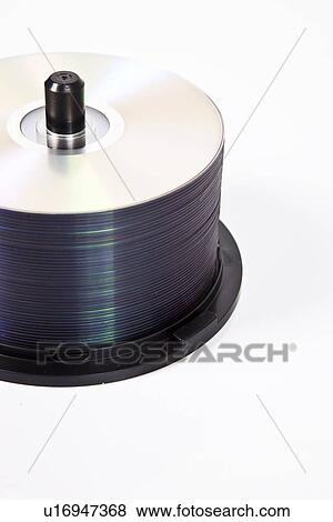 Stack of compact discs on a spindle over white background View Large Photo Image Stock Photo - Stack of compact discs on a spindle over white background. Fotosearch
