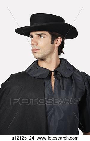 Thoughtful man dressed as Zorro against gray background View Large Photo Image Picture - Thoughtful man dressed as Zorro against gray background. Fotosearch