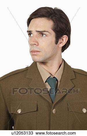 Thoughtful man in military uniform looking away against gray background View Large Photo Image Stock Image - Thoughtful man in military uniform looking away against gray background. Fotosearch