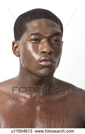 Stock Image - Thoughtful young African American man sweating over white background. Fotosearch