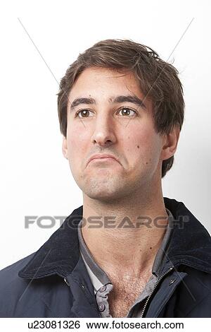 Thoughtful young man looking away against white background View Large Photo Image Stock Photograph - Thoughtful young man looking away against white background. Fotosearch