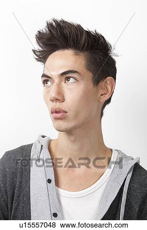 Thoughtful young mixed race man looking away against white background View Large Photo Image Stock Photo - Thoughtful young mixed race man looking away against white background. Fotosearch