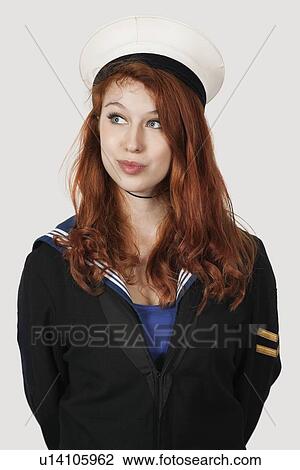 Thoughtful young woman in sailor's uniform looking away against gray background View Large Photo Image Stock Image - Thoughtful young woman in sailor's uniform looking away against gray background. Fotosearch