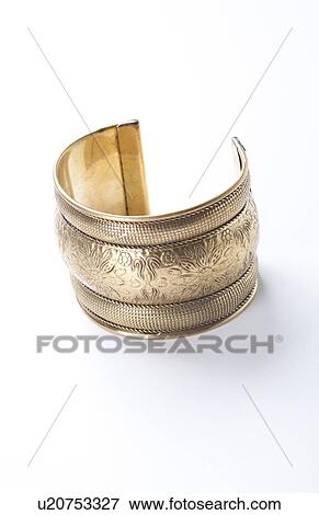 Trendy gold bracelet over white background View Large Photo Image Stock Photo - Trendy gold bracelet over white background. Fotosearch