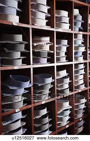 Stock Photo - Variety of shirts arranged on shelves in a clothing store. Fotosearch