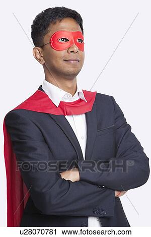 Young Asian businessman in superhero's costume with arms crossed against white background View Large Photo Image Stock Image - Young Asian businessman in superhero's costume with arms crossed against white background. Fotosearch