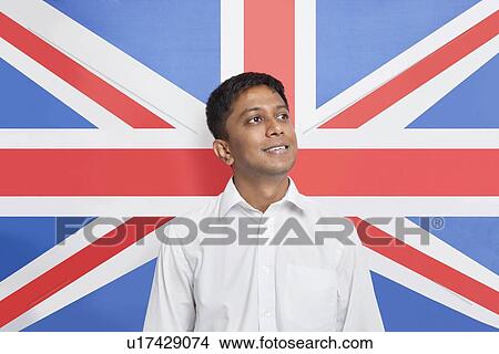 Young Asian man in shirt day dreaming against British flag View Large Photo Image Picture - Young Asian man in shirt day dreaming against British flag. Fotosearch