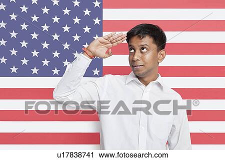 Young Asian man in shirt saluting against American flag View Large Photo Image Stock Image - Young Asian man in shirt saluting against American flag. Fotosearch