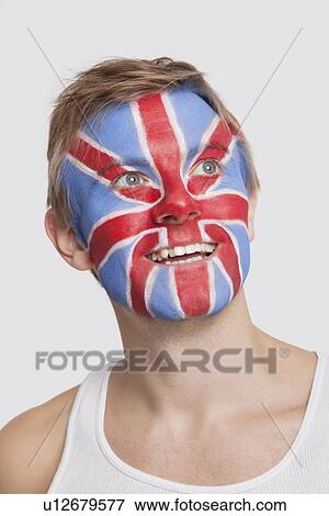 Young Caucasian man with British flag painted on face day dreaming against white background View Large Photo Image Stock Photo - Young Caucasian man with British flag painted on face day dreaming against white background. Fotosearch