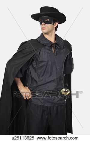 Young man dressed as Zorro against gray background View Large Photo Image Stock Photography - Young man dressed as Zorro against gray background. Fotosearch