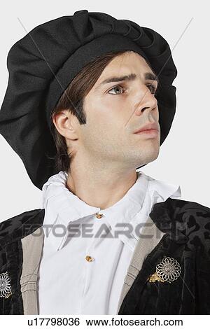 Young man in old-fashioned costume against gray background View Large Photo Image Stock Photograph - Young man in old-fashioned costume against gray background. Fotosearch