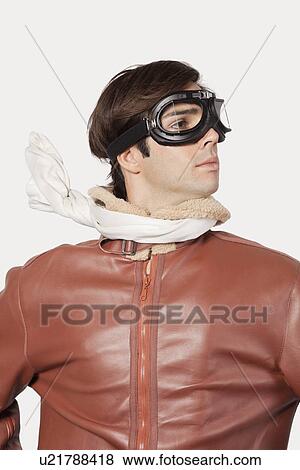 Stock Photo - Young man in old-fashioned pilot costume over gray background. Fotosearch
