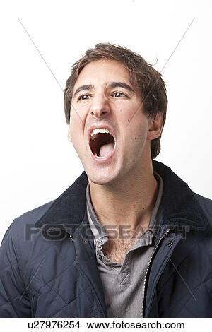 Picture - Young man shouting against white background. Fotosearch