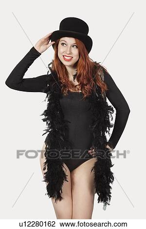 Young woman old fashioned magician costume looking away against gray background View Large Photo Image Stock Image - Young woman old fashioned magician costume looking away against gray background. Fotosearch